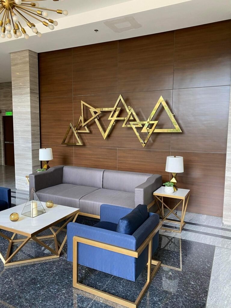 Modern lobby lounge at The Trion Towers, BGC, Taguig with contemporary furniture and gold decor.