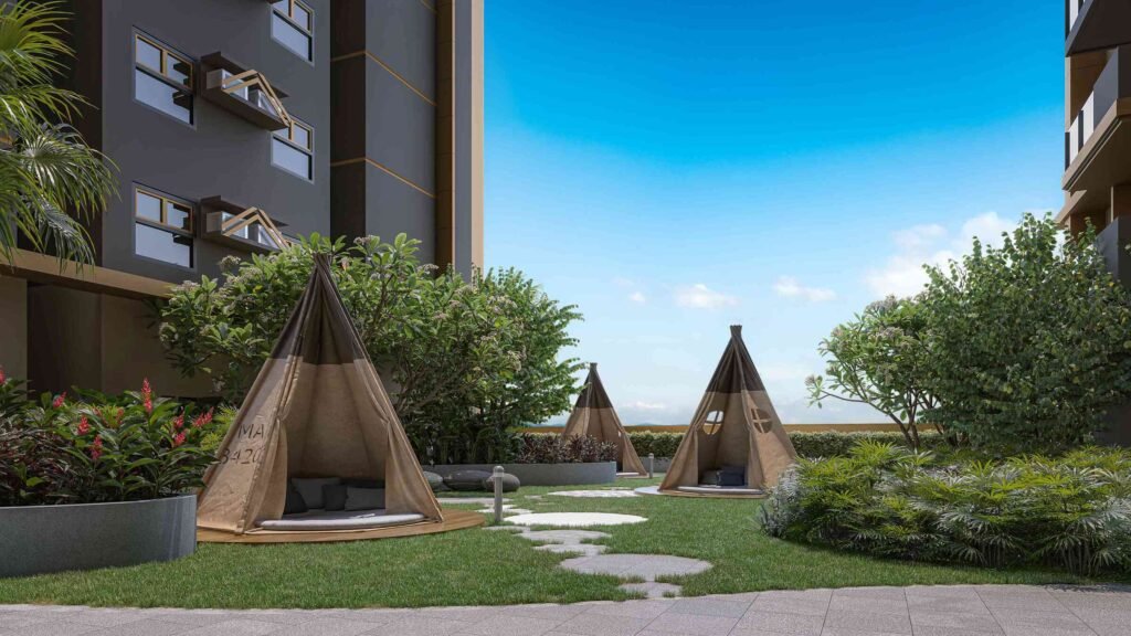 Outdoor condominium garden with teepee tents, lush greenery, and peaceful sky view